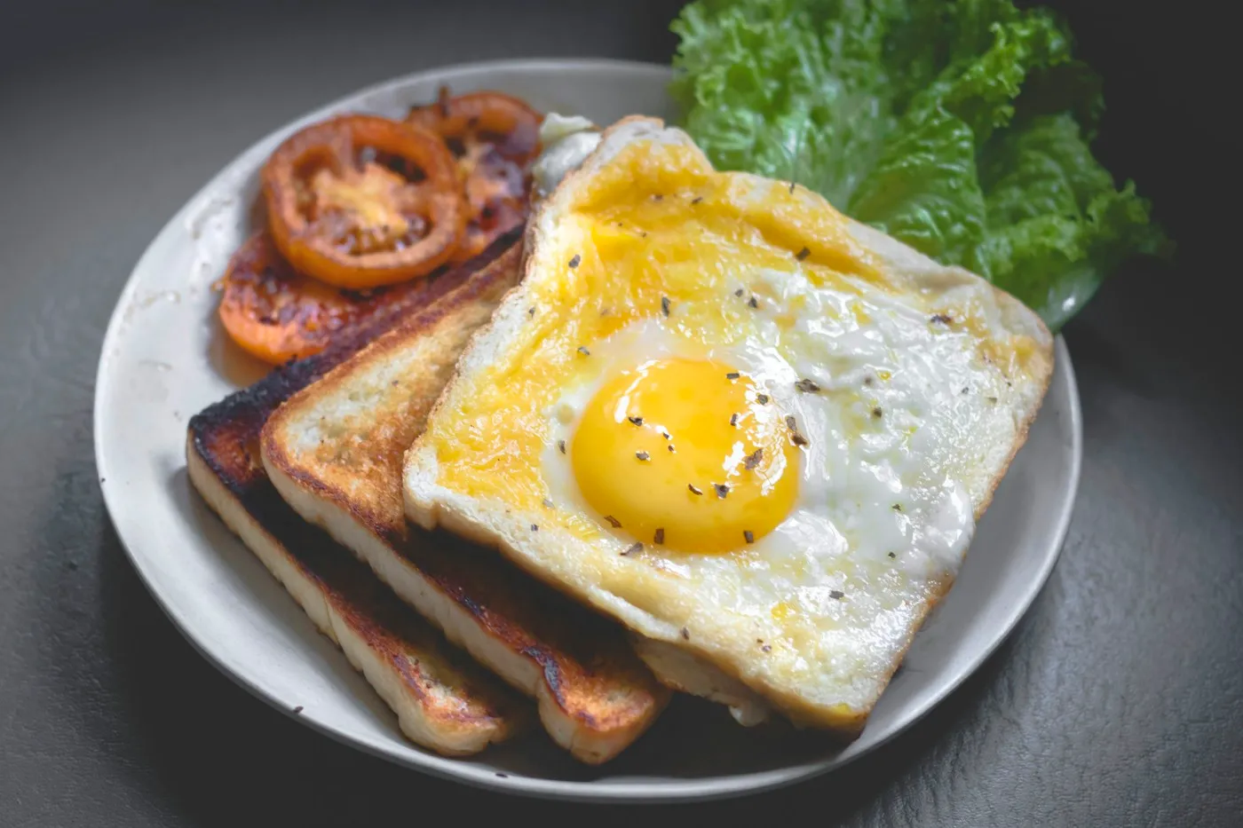 Eggs on toast on a ceramic plate; illustrative stock photograph, not the bakery’s menu